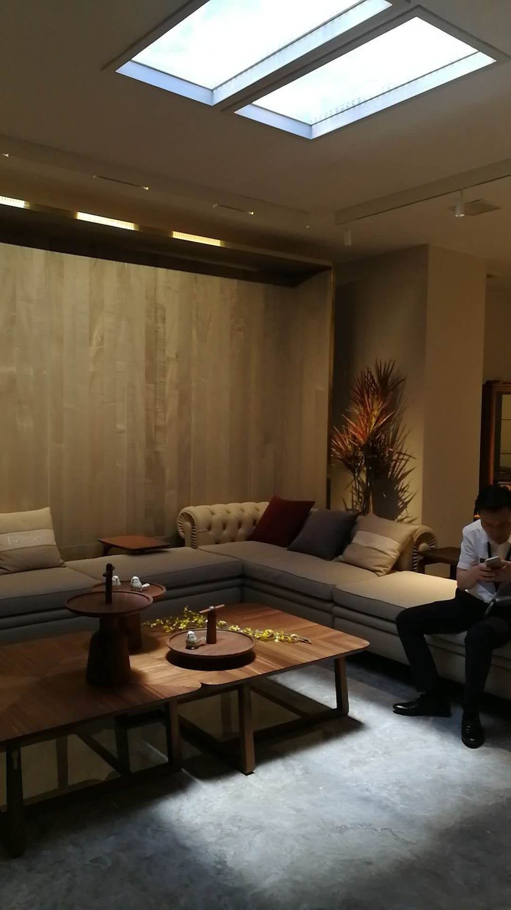 Second angle of the same villa living room, showing the skylights above the sofa seating area.