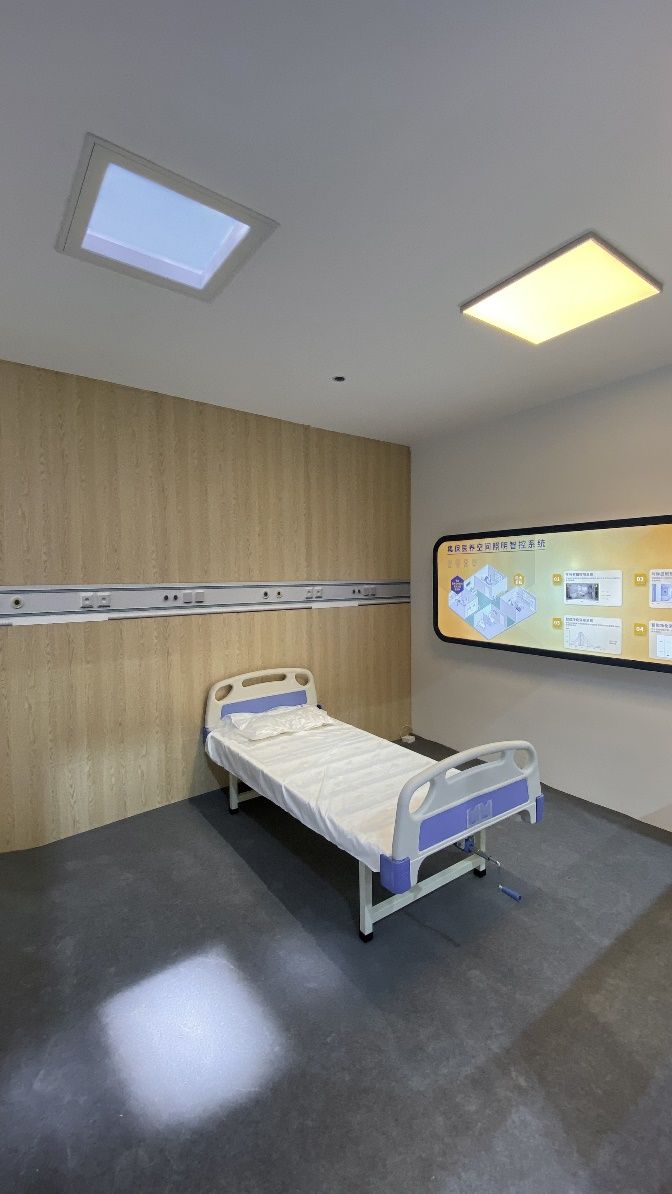 Static cloud skylight above a light-therapy patient room, showing the fitting in a real clinical setting rather than the marketing booth - corrected from the previous description, which mistakenly described this as the trade show image.