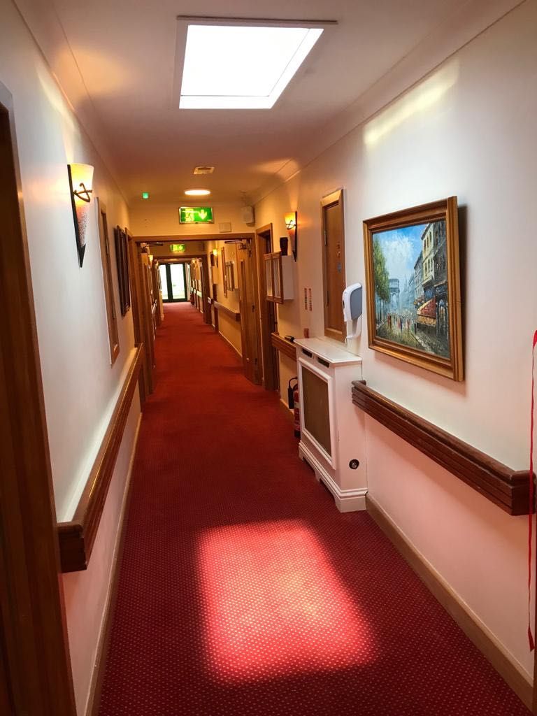 1200x600mm static cloud artificial skylight in a retirement village corridor, reducing the institutional feel of the internal walkway and supporting residents' orientation and mood.