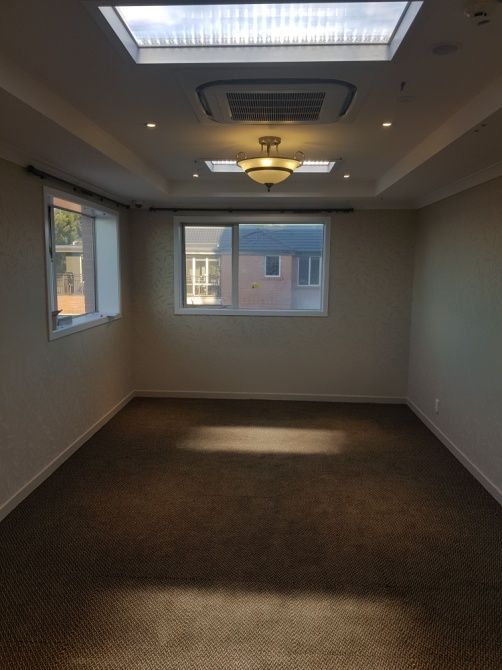 1200x600mm recessed static cloud skylight within the same retirement village bedroom, set to daylight 10,000K to boost alertness and mood during the day.