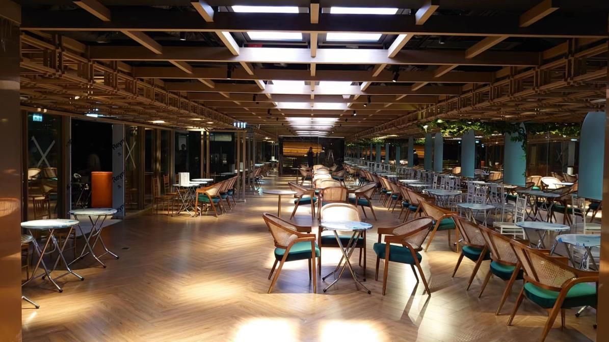 Large grid of blue sky SOL-0606 600x600mm skylights within a restaurant food hall, bringing daylight across a wide dining floor.