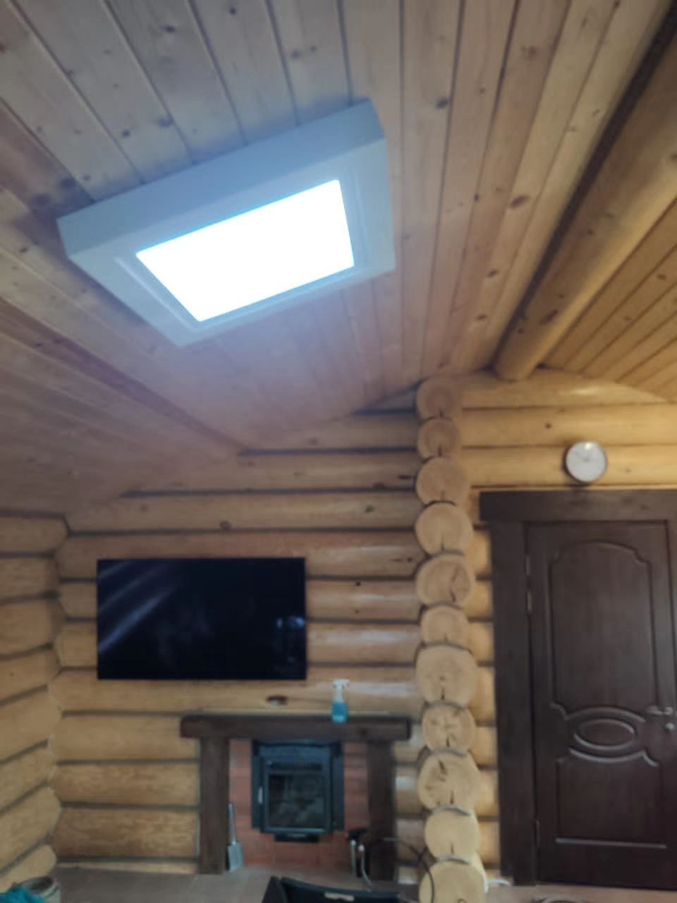 Static cloud skylight above a living room with a traditional carved timber partition, bringing daylight into an internal seating area.