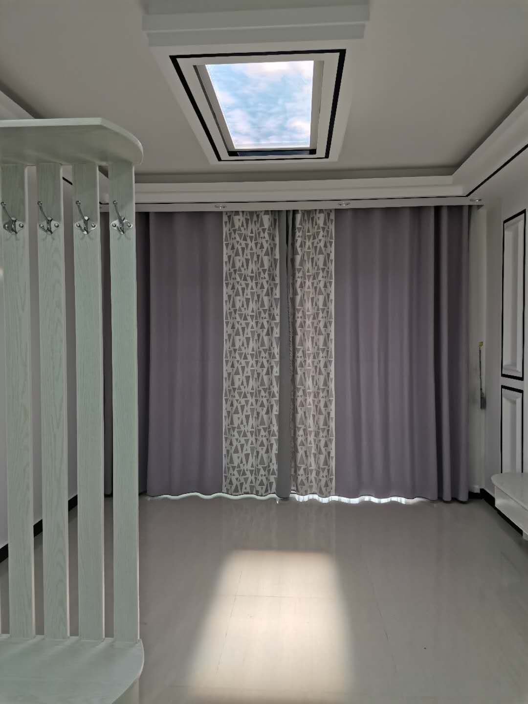 Static cloud skylight above a nursery/bedroom, giving a young child's room natural daylight without relying on a window.