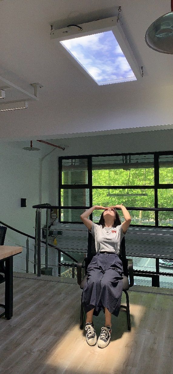 Person beneath an artificial skylight in a university lighting research room