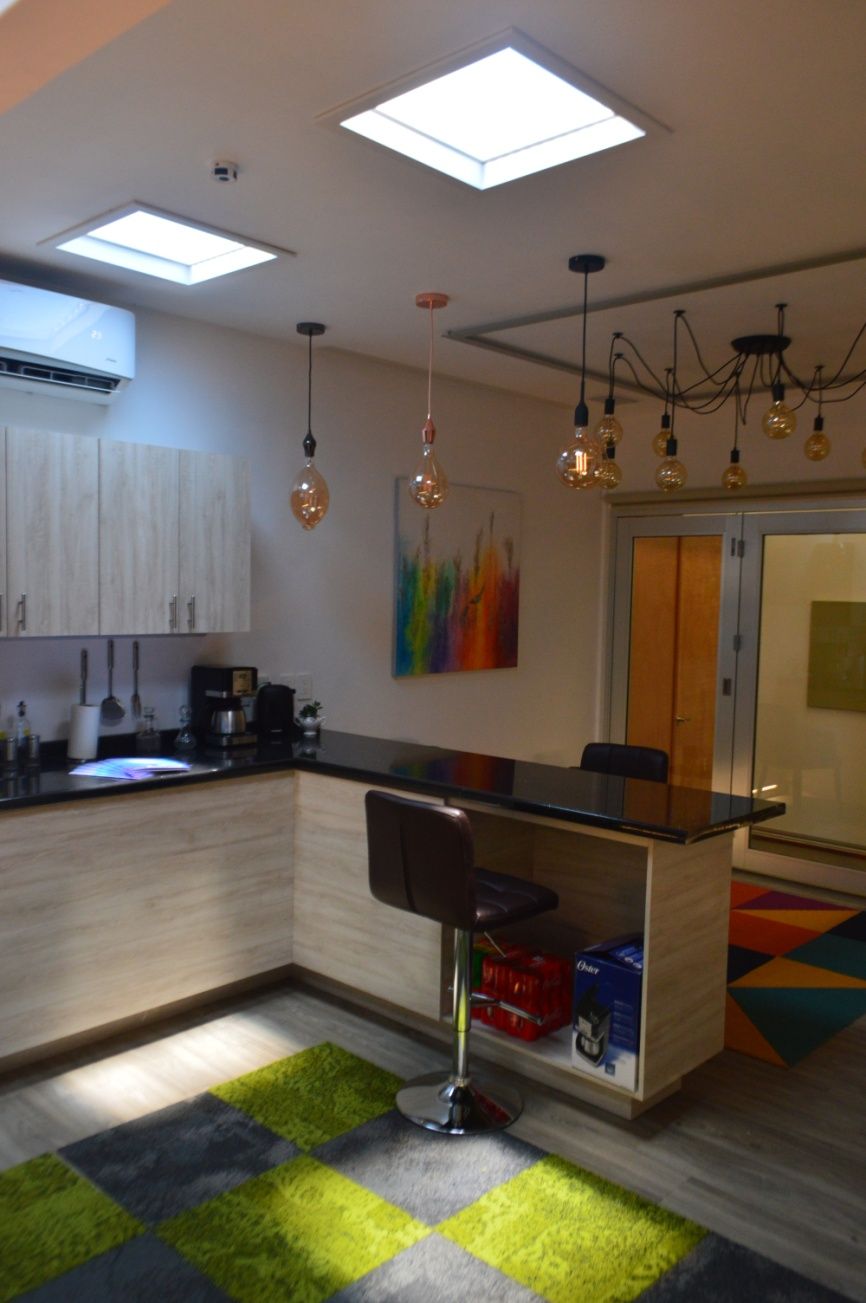 Two 600x600mm artificial skylights above a kitchen and dining bar