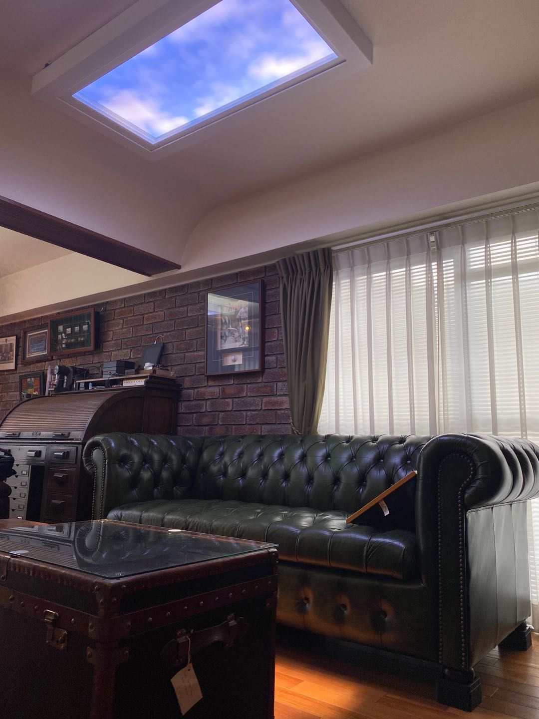 Artificial skylight in a period-style room with exposed brick