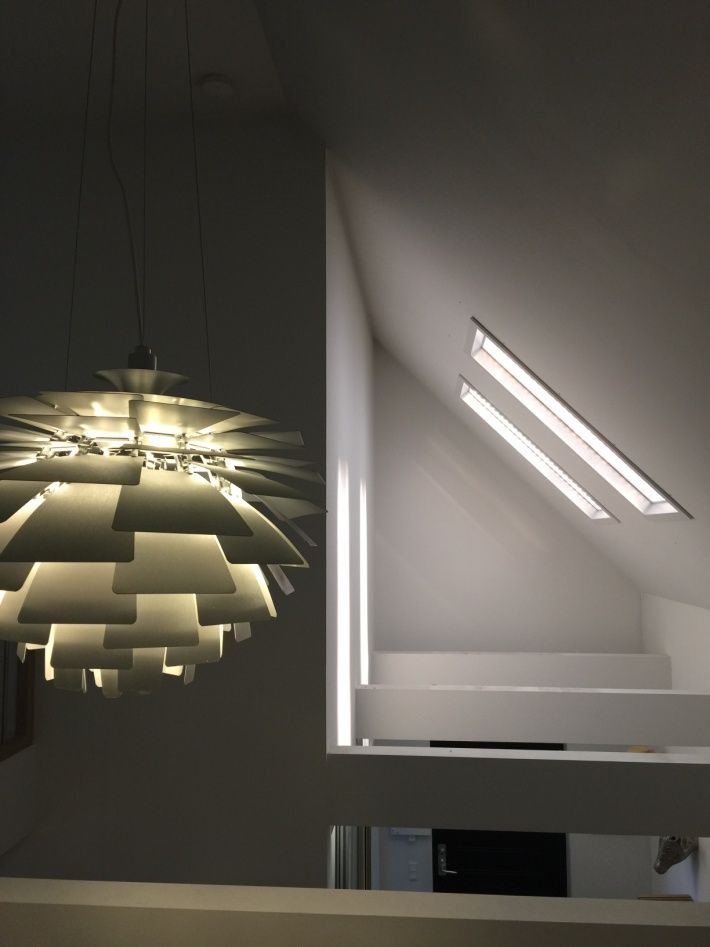Static cloud skylight above an open-plan kitchen and dining area, adding daylight to an internal space away from the windows.