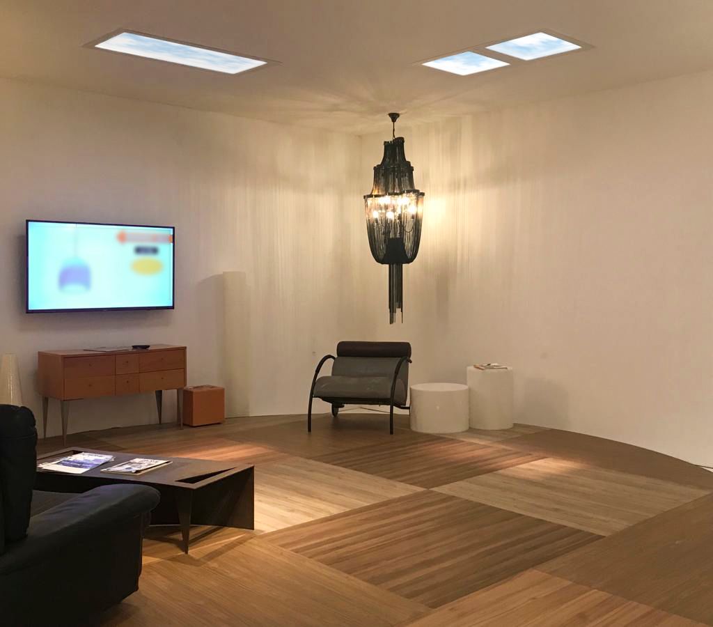 Windowless living room using a mixture of 1200x600mm and 600x600mm static cloud skylights, adding daylight to an internal space centred around a statement chandelier.