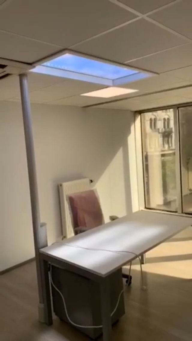 Static cloud skylight above a small treatment/consulting room in a private hospital, bringing natural-feeling light into a windowless clinical space. As a dynamic sky panel, it also offers slow-moving clouds, an optional starry night mode after dark, and an adjustable colour temperature from crisp all-white daylight through to a warmer all-warm tone, letting the space be tuned through the day and evening rather than staying fixed like a static image.