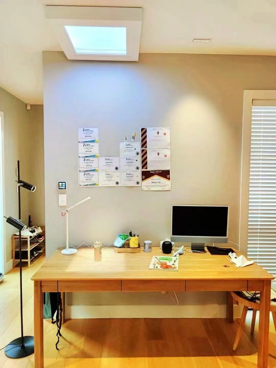 Surface-mounted blue sky skylight above a children's study desk, giving a homework space natural-feeling light.