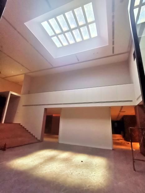 Grid of 1200x600mm static cloud skylight installed at a height of 8m above floor level within a museum lobby.