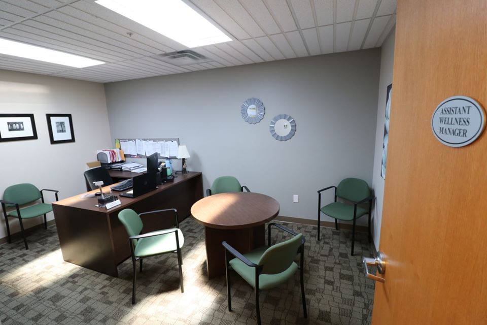 Static cloud skylight above a wellness manager's office in the same building, bringing daylight into a meeting space to support staff wellbeing.