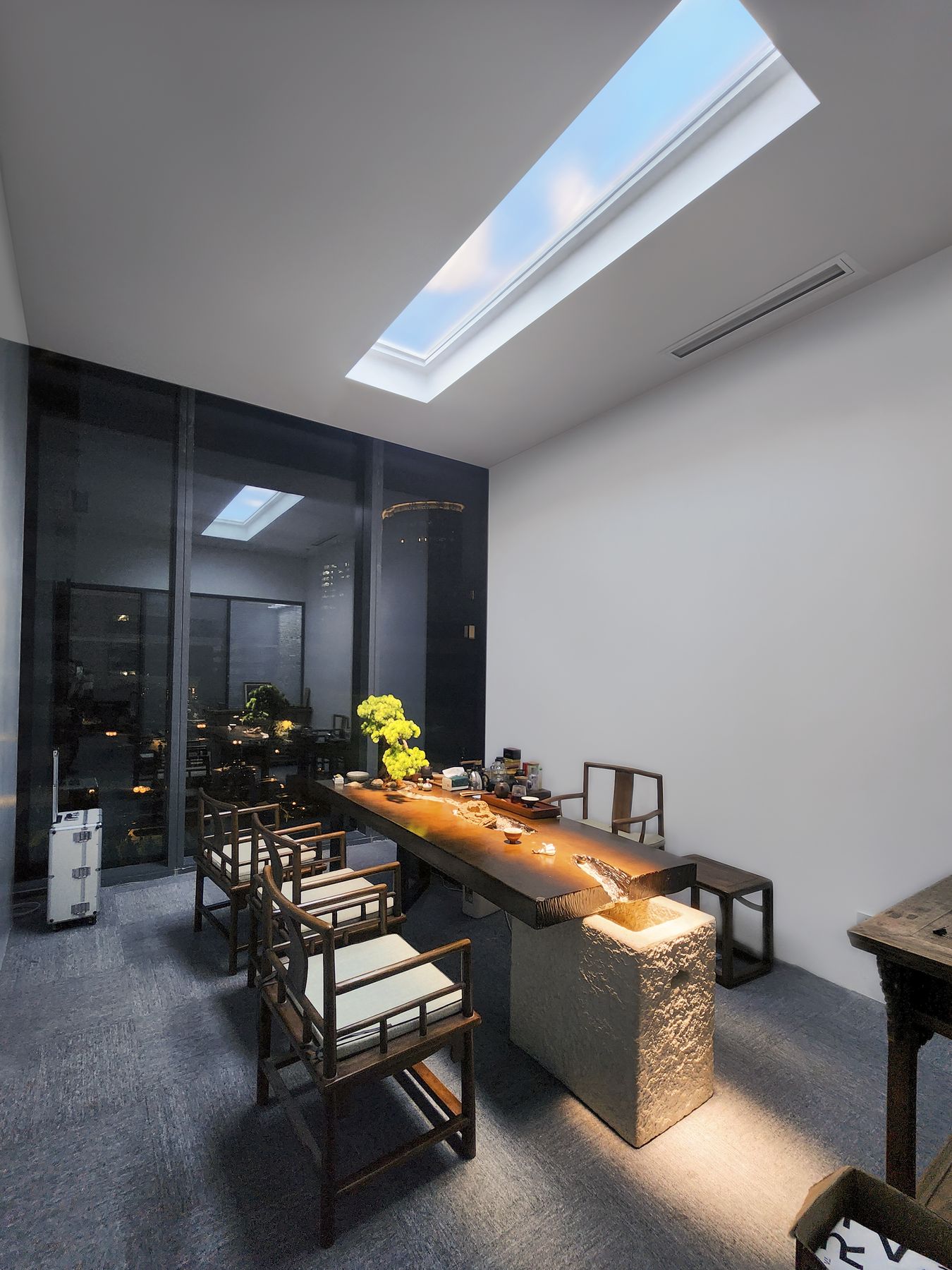 Recessed 2400x600mm dynamic sky skylight above a meeting room, its slow-moving clouds chosen over a static image to keep the room feeling alive during longer meetings while still reading as a calm, natural daylight source rather than a distracting light. As a dynamic sky panel, it also offers an optional starry night mode after dark and an adjustable colour temperature from crisp all-white daylight through to a warmer all-warm tone, letting the space be tuned through the day and evening rather than staying fixed like a static image.