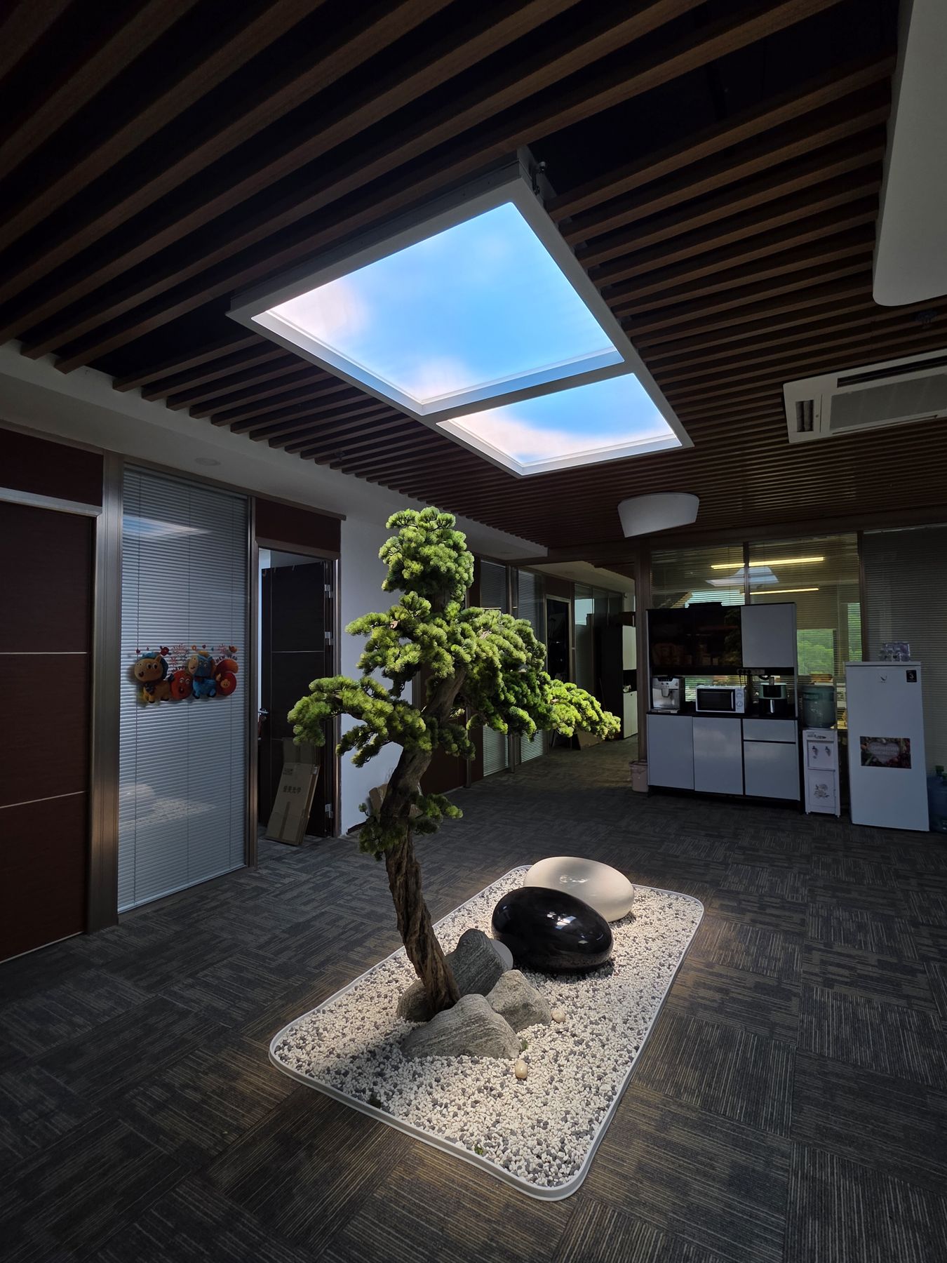 1200x1200mm artificial skylight in the same corporate head office, its large square format giving a stronger visual presence over a boardroom or breakout area where the skylight itself becomes a feature of the space.