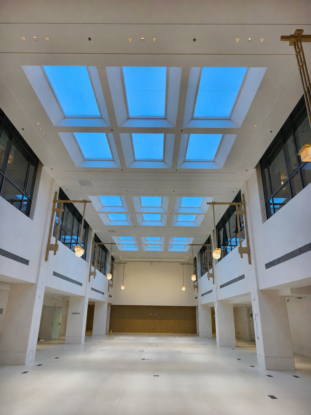 Grid of large artificial skylights installed 10m above a lobby floor