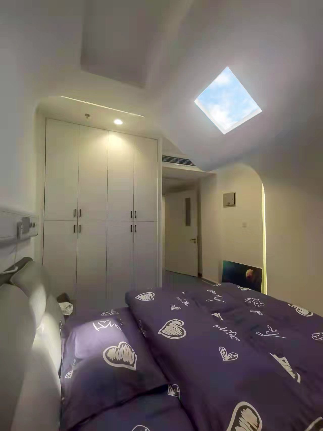 Static cloud skylight positioned above a hospital light-therapy patient bedroom directed at the patients head to give direct sunlight therapy to regulate circadian rythem to support the patient's sleep/wake cycle.