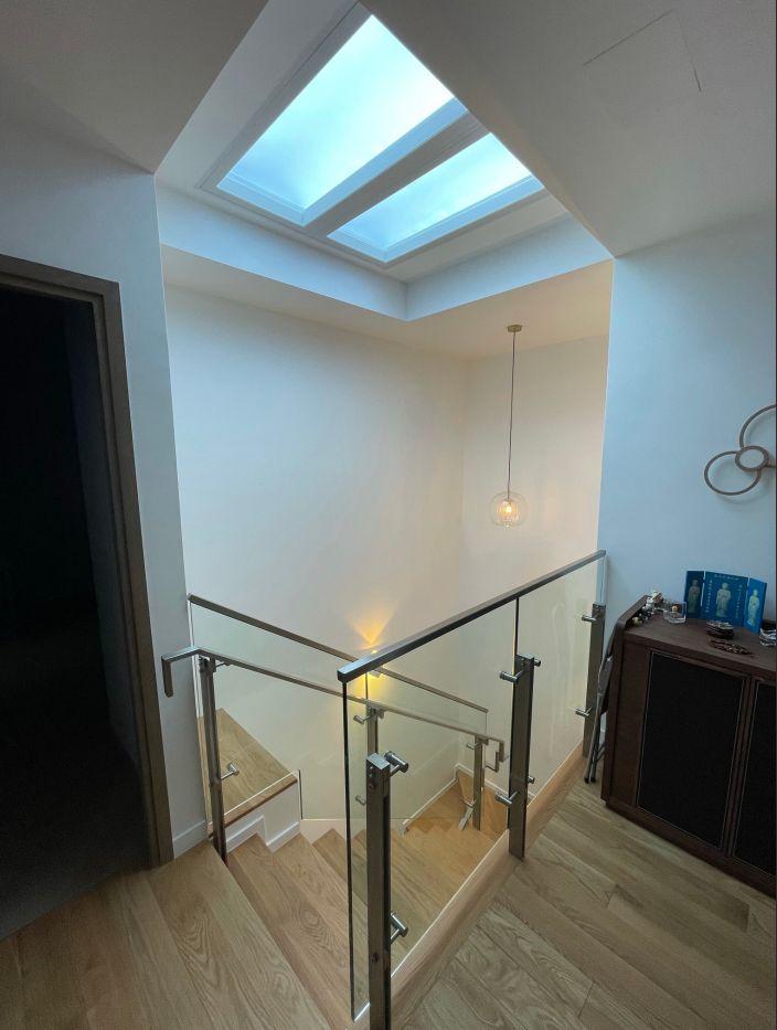 Another angle behind the scenes installation of two rows of static cloud skylights using a mixture of 1200x600 and 600x600 to achieve the desired design within a villa living room, filling a large open ceiling with daylight across the full width of the room.